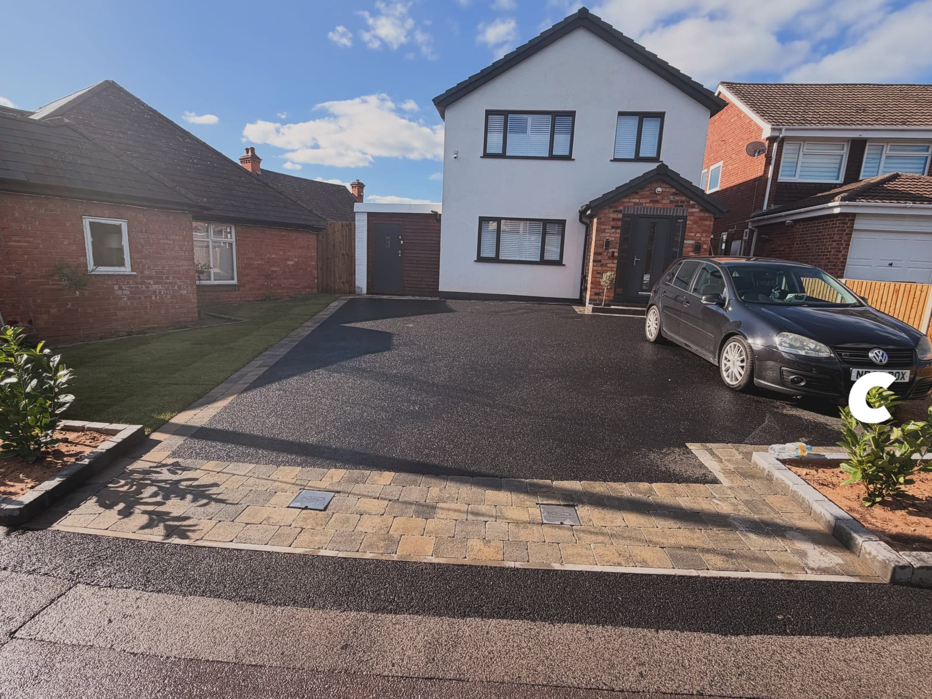 Wide tarmac driveway finished with a block paved entrance